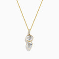 A 14K yellow gold necklace featuring a pendant with an oval and teardrop-shaped white topaz and diamond, stacked vertically for an elegant look.