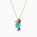 This 14K Yellow Gold necklace features a Seahorse Pendant adorned with turquoise, sapphire, tsavorite, and diamond gemstones on a delicate chain.