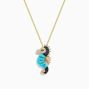 This 14K Yellow Gold necklace features a Seahorse Pendant adorned with turquoise, sapphire, tsavorite, and diamond gemstones on a delicate chain.