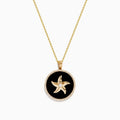 The Seaside 14K Yellow Gold Black Agate and Diamond Starfish Pendant features a gold starfish with a central gem on black agate, edged with sparkling diamonds and suspended from a yellow gold chain.