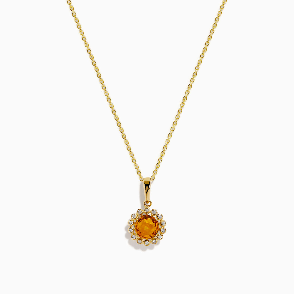 The 14K Yellow Gold Citrine and Diamond Halo Pendant features a round citrine center with a diamond halo, set on a gold chain and displayed against a white background.