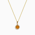 The 14K Yellow Gold Citrine and Diamond Halo Pendant features a round citrine center with a diamond halo, set on a gold chain and displayed against a white background.