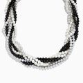 A close-up of the 925 Sterling Silver Fresh Water Pearl Torsade Necklace, featuring several intertwined strands of pearls layered elegantly against a white background.
