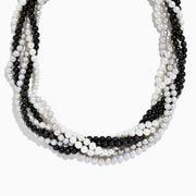 A close-up of the 925 Sterling Silver Fresh Water Pearl Torsade Necklace, featuring several intertwined strands of pearls layered elegantly against a white background.