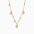 The 14K Yellow Gold Pearl and Diamond Necklace features small round charms and lustrous pearls, with some charms adorned with sparkling diamonds, creating an elegant and delicate design against a white background.