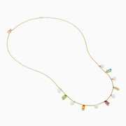 The Mosaic 14K Yellow Multi Color Gemstone Freshwater Pearl and Diamond Necklace features evenly spaced freshwater pearls with green, yellow, purple, clear, and blue gemstones, all set in 14K yellow gold.
