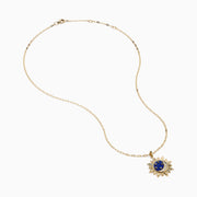 The 14K Yellow Gold Lapis and Diamond Celestial Sunburst Pendant features a blue lapis center, gold stars, a diamond-set crescent, and an elongated gold chain for an elegant celestial touch.