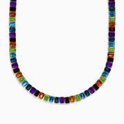 The Mosaic 14K Yellow Gold Multi Gemstone Necklace showcases square-cut gems in vibrant purple, orange, green, and blue set in a repeating pattern for a striking look on a white background.