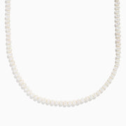 The 14K Yellow Gold Freshwater Pearl and Paperclip Chain Necklace features small white freshwater pearls strung on the lower section, connected to a delicate gold paperclip chain, shown on a plain white background.