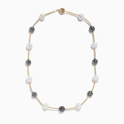 The 14K Yellow Gold Tahitian and Fresh Water Pearl Necklace features alternating black Tahitian pearls and white freshwater pearls, evenly spaced along a yellow gold chain and shown on a white background.