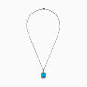 The Ocean Bleu 925 Sterling Silver and 18K Yellow Gold Blue Topaz Pendant features a rectangular faceted blue topaz framed by twisted silver and yellow gold accents on a sterling silver chain.