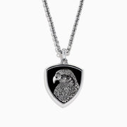 The Mens 925 Sterling Silver Onyx Pendant features a detailed engraved eagle head on a black shield-shaped background, crafted from sterling silver and suspended from a sleek silver chain.