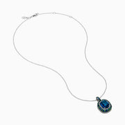 The 925 Sterling Silver Blue Topaz Cushion Multi Gemstone Halo Pendant features a cushion-cut blue topaz, accented by small blue and green stones in a striking halo design.