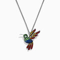 The 925 Safari Sterling Silver Multi Sapphires Humming Bird Pendant features a sterling silver chain and a pendant adorned with green, blue, yellow, and red sapphires that accentuate the bird’s wings, body, and tail.