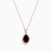 The 14K Rose Gold Garnet and Diamond Pendant features a teardrop-shaped deep red garnet accented by a halo of sparkling diamonds on a delicate rose gold chain.