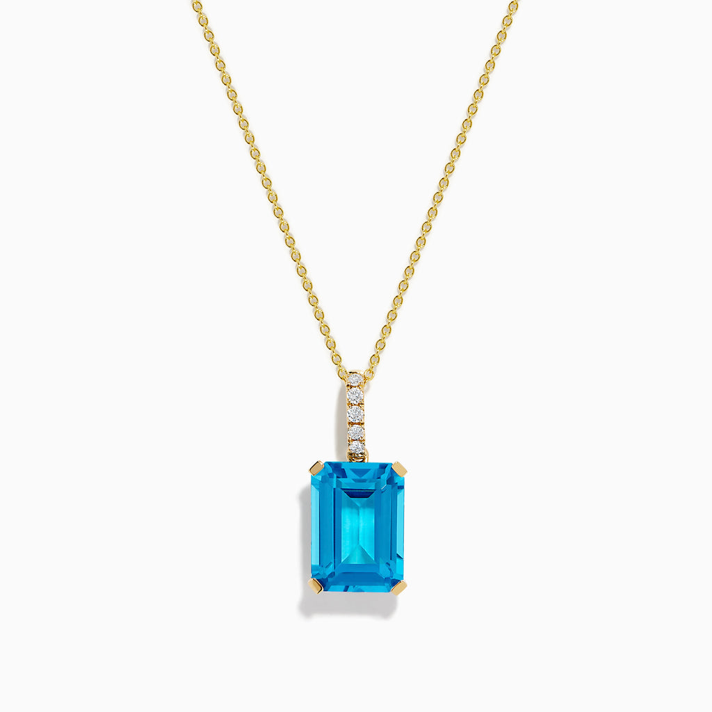 The 14K Yellow Gold Blue Topaz and Diamond Pendant features a large emerald-cut blue topaz accented by a vertical row of sparkling white diamonds for an elegant, polished look.