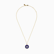 A 14K yellow gold pendant featuring a round blue lapis stone with a white and black diamond compass design—a striking addition to your jewelry collection.