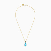 The Ocean Bleu 14K Yellow Gold Blue Topaz Pendant features an emerald-cut blue topaz in gold prongs, showcased on a gold chain against a white background.