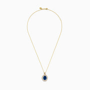 The Ocean Blue 14K Gold London Blue Topaz and Diamond Pendant features an oval-shaped topaz with a diamond teardrop design, accented by two rows of sparkling white diamonds.