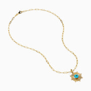 The 14K Yellow Gold Turquoise and Diamond Evil Eye Pendant features a sunburst design with a vivid blue and black evil eye center, accented by sparkling diamonds along the edges.