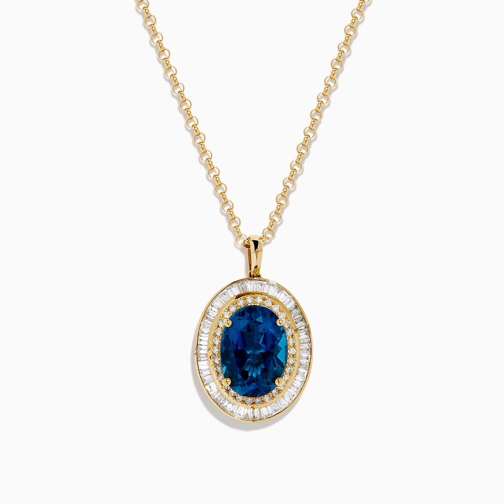 The 14K Yellow Gold London Blue Topaz and Diamond Double Halo Pendant features an oval London Blue Topaz and sparkling white diamonds, set on a gold chain necklace.