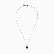 The Effy Hematian 18K White Gold Sapphire and Diamond Halo Pendant features a cushion-cut deep blue sapphire surrounded by sparkling diamonds, showcased on a plain white background.