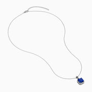 The Nahla Siri 14K Gold Tanzanite and Diamond Pendant features a square blue tanzanite gemstone surrounded by sparkling diamonds, displayed against a white background.