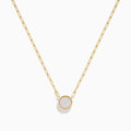 The 14K Yellow Gold Opal Bezel Paperclip Chain Pendant features a single round white opal in a simple, elegant bezel setting on a delicate yellow gold chain.