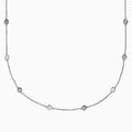 The 14K White Gold 36 Inch 3.00ct Diamond Station Necklace features a white gold chain with evenly spaced round bezel-set diamonds for a timeless, elegant look.