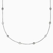 The 14K White Gold 36 Inch 3.00ct Diamond Station Necklace features a white gold chain with evenly spaced round bezel-set diamonds for a timeless, elegant look.
