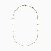 The 14K Yellow Gold Diamond Station Necklace, 1.00 TCW, features evenly spaced round diamonds in bezel settings on a delicate gold chain, shown elegantly against a white background.