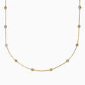 The 14K Yellow Gold Diamond Station Necklace, 1.00 TCW, features evenly spaced round diamonds in bezel settings on a delicate gold chain, shown elegantly against a white background.