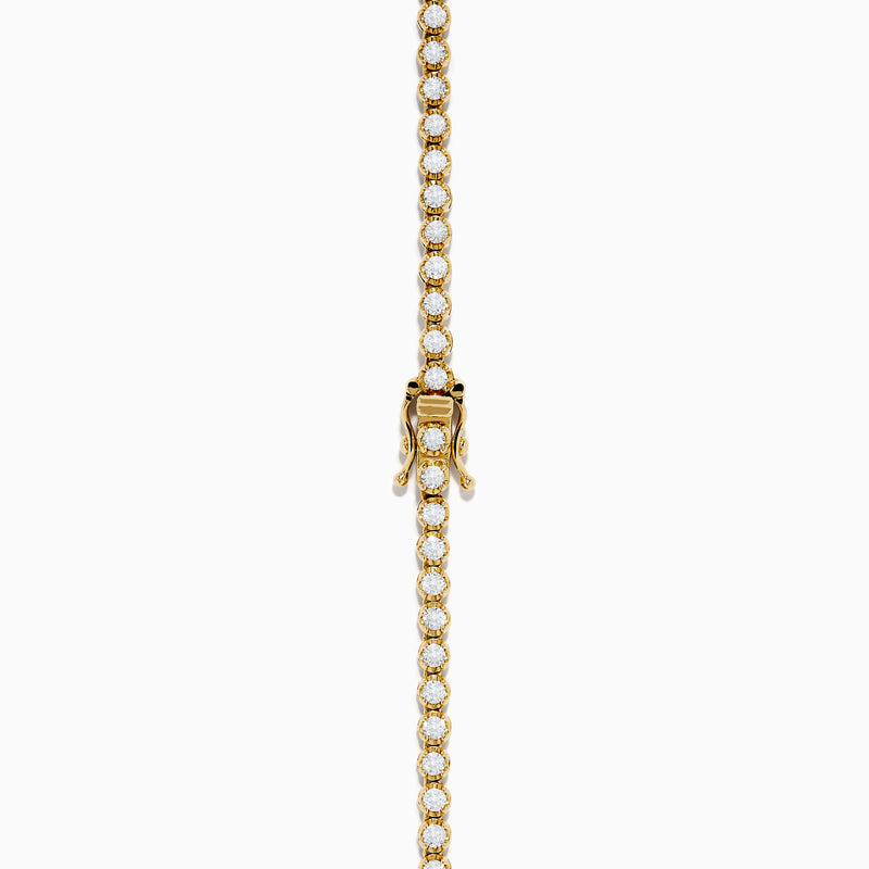 The 14K Yellow Gold Miracle Set Diamond Graduated Tennis Necklace showcases a single row of closely set, sparkling round diamonds in a gentle curve on yellow gold.