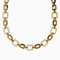The D'Oro 14K Yellow Gold Diamond Necklace features rectangular links, some adorned with sparkling diamonds, displayed on a white background.