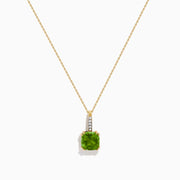 The 14K Yellow Gold Periodt and Diamond Pendant features a square-cut green gemstone and a vertical row of small white diamonds above it, creating an elegant and stylish necklace.