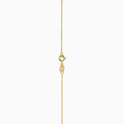 The 14K Yellow Gold Periodt and Diamond Pendant features a square-cut green gemstone and a vertical row of small white diamonds above it, creating an elegant and stylish necklace.