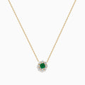 The Brasilica 14K Yellow Gold Emerald and Diamond Necklace features a round green emerald pendant with sparkling diamonds in a flower shape, set in white metal on a delicate gold chain.