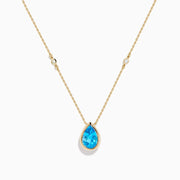 The Ocean Bleu 14K Yellow Gold Blue Topaz and Diamond Necklace features a teardrop blue topaz pendant with two round diamonds set on a delicate chain, shown on a white background.