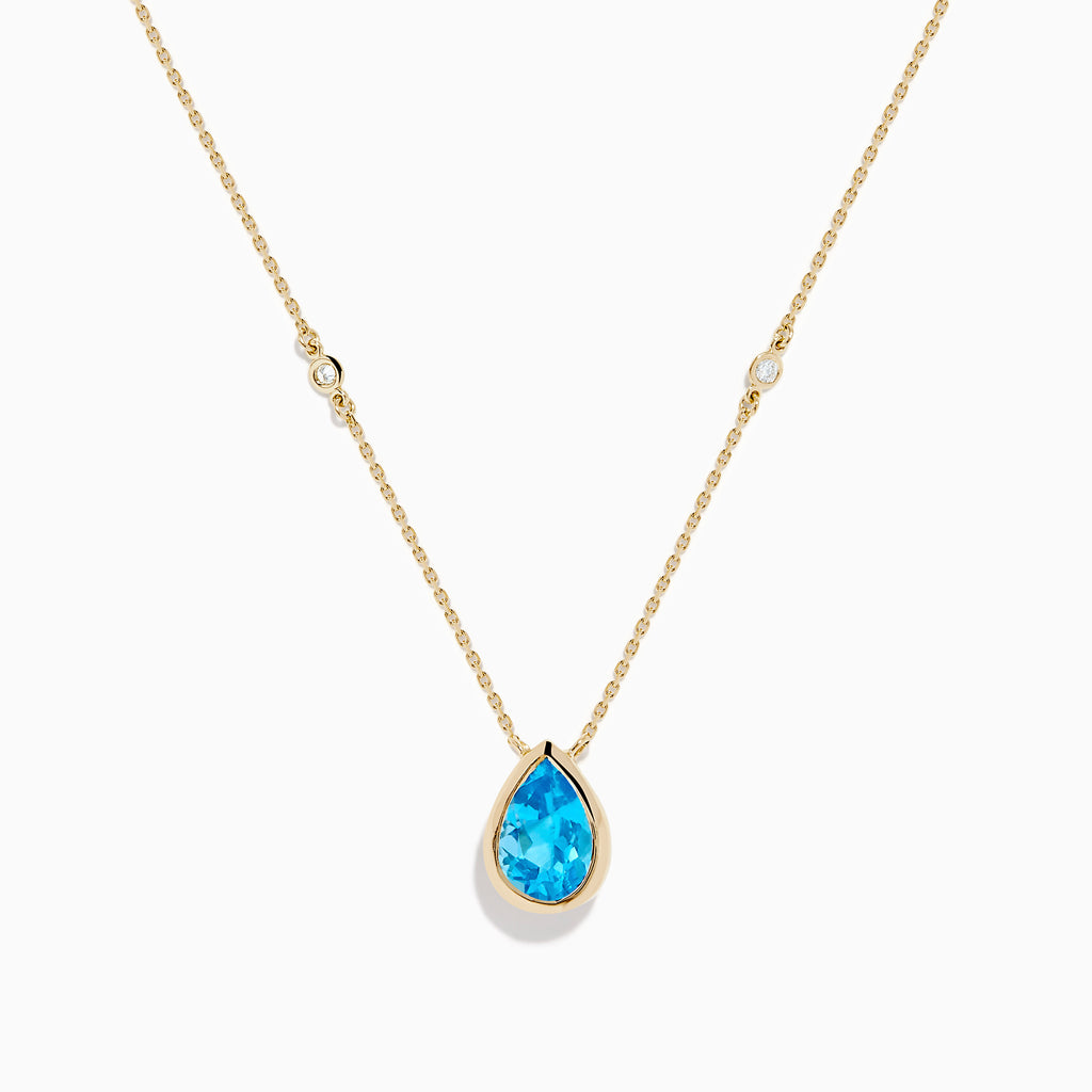 The Ocean Bleu 14K Yellow Gold Blue Topaz and Diamond Necklace features a teardrop blue topaz pendant with two round diamonds set on a delicate chain, shown on a white background.