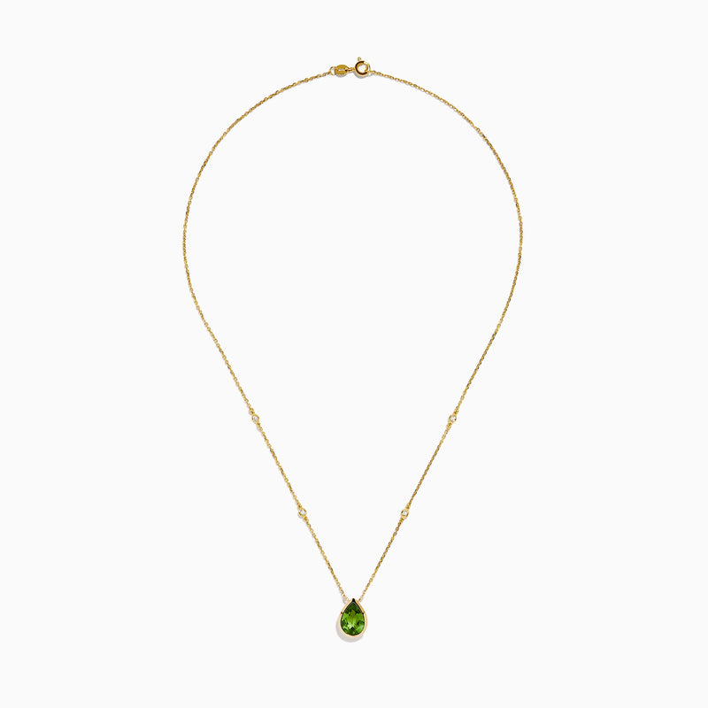 The 14K Yellow Gold Peridot and Diamond Necklace features a delicate gold chain with a teardrop-shaped green peridot pendant and two small round diamonds set along the chain.