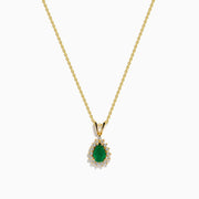 The 14K Yellow Gold Emerald and Diamond Pear Halo Pendant features an emerald teardrop surrounded by a diamond halo, set on a gold chain.