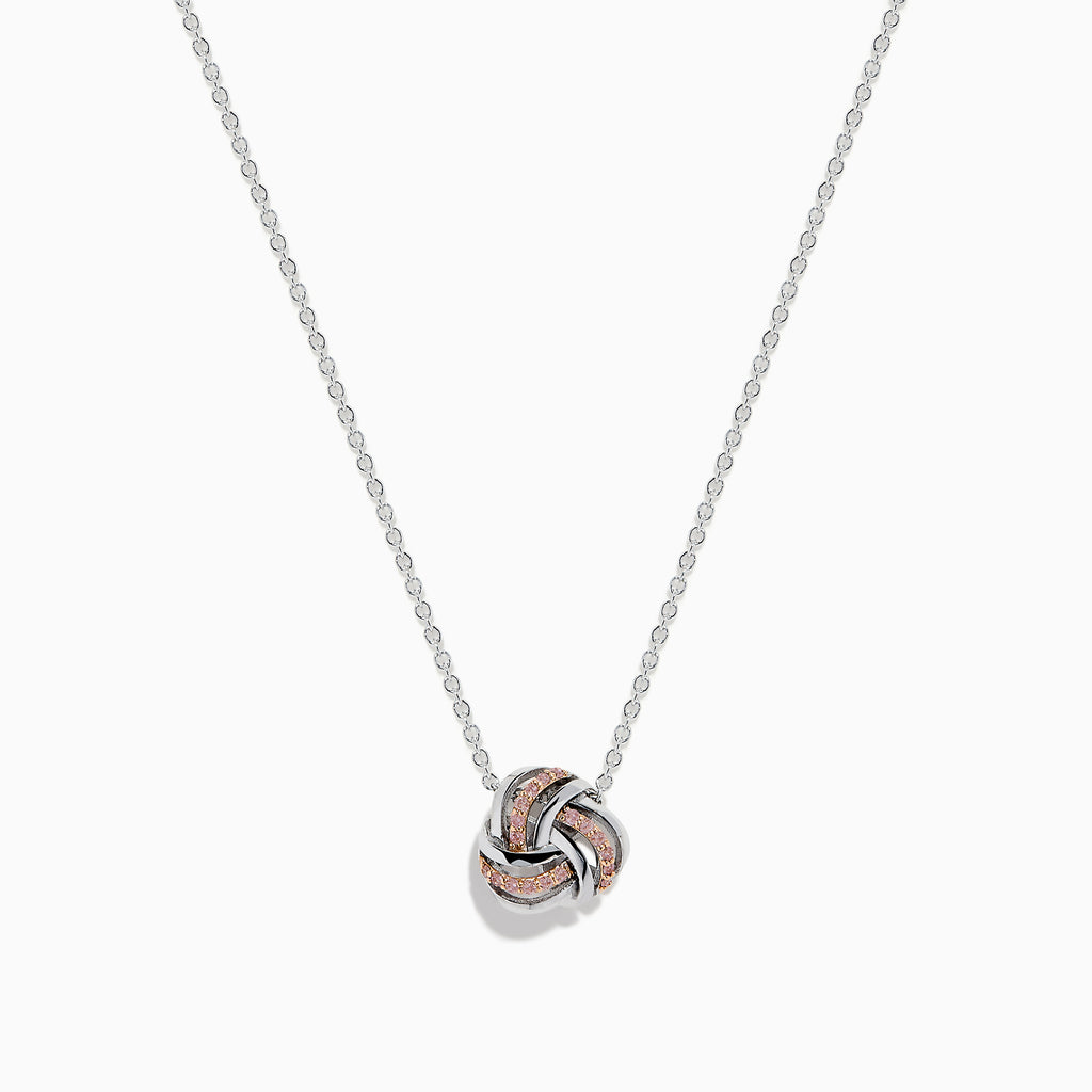 The 14K White Gold Pink Diamond Love Knot Pendant features intertwined rose gold and white gold tones with a polished, textured finish, delicately centered on a silver chain.