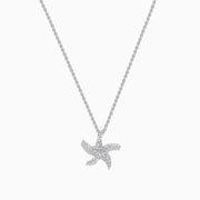 The Novelty 14K White Gold Diamond Starfish Pendant features a starfish-shaped design encrusted with sparkling diamonds, beautifully displayed on a plain white background.