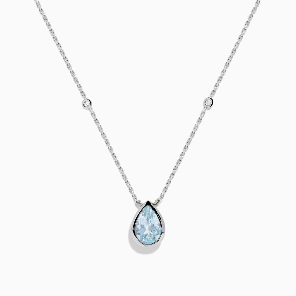 The Aquarius 14K Yellow Gold Aquamarine Necklace features a teardrop-shaped light blue gemstone pendant and small round crystal accents along the chain—an elegant gift, beautifully displayed on a white background.