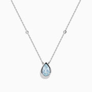 The Aquarius 14K Yellow Gold Aquamarine Necklace features a teardrop-shaped light blue gemstone pendant and small round crystal accents along the chain—an elegant gift, beautifully displayed on a white background.
