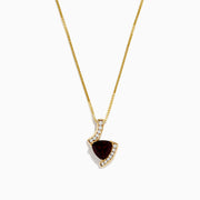 The 14K Yellow Gold Garnet and Diamond Pendant features a deep red, triangular garnet accented with small diamonds in a curved, asymmetrical design.
