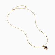 The 14K Yellow Gold Garnet and Diamond Pendant features a deep red, triangular garnet accented with small diamonds in a curved, asymmetrical design.