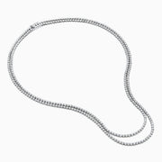 Two elegant Pave Classica 14K White Gold Diamond Tennis Necklaces with closely set, sparkling diamonds are layered together against a white background, forming gentle, symmetrical curves.
