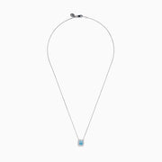 The Lab Grown Blue and White Diamond Halo Necklace in 14K White Gold features a square blue and white diamond pendant surrounded by clear stones, elegantly displayed against a white background.