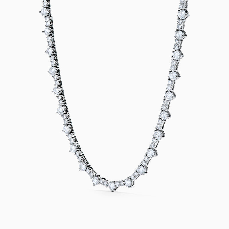 The Lab Grown Diamond Tennis Necklace in 14K White Gold showcases a continuous row of closely set round lab grown diamonds, elegantly displayed on a plain white background.